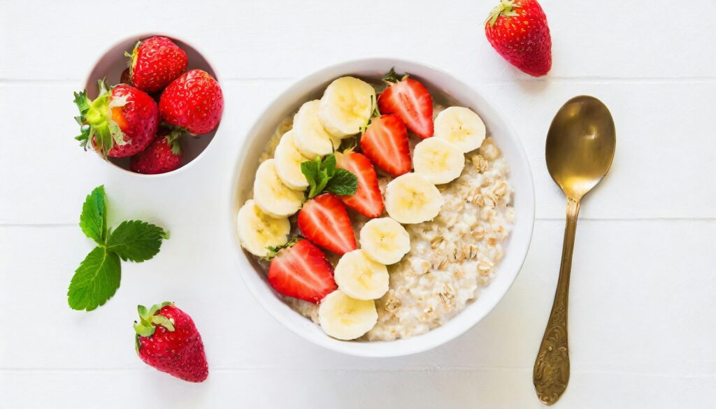 Gut healthy plant-based oatmeal bowl topped with bananas and strawberries.