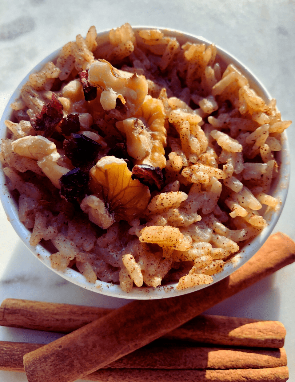 Close-up of warm jasmine rice pudding with a sprinkle of cinnamon.