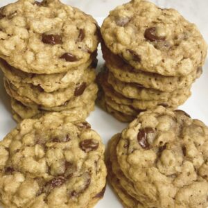 Vegan oatmeal chocolate chip cookies stacked on a plate, made with plant-based ingredients