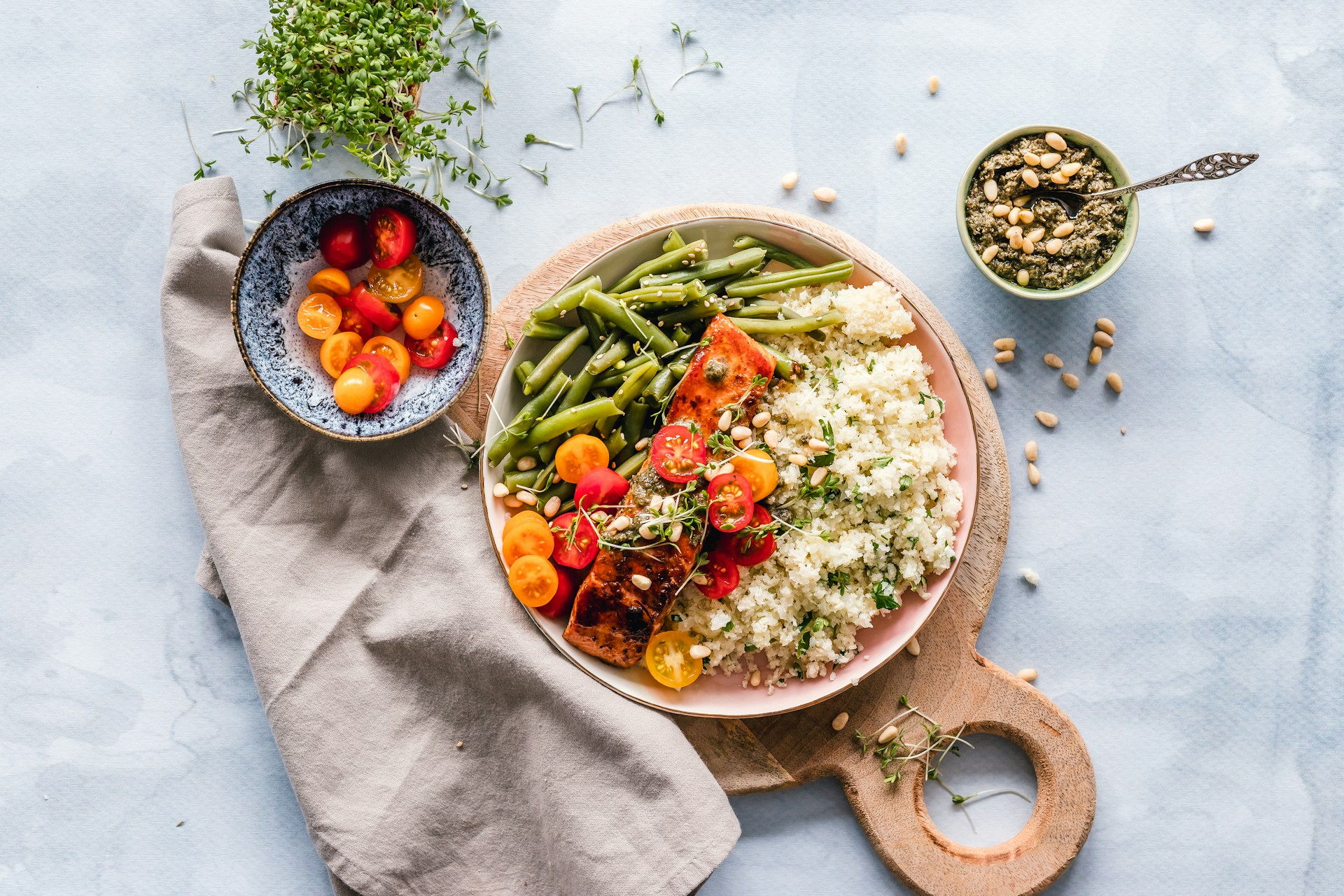 Plate of a gut-healthy meal featuring oven-roasted salmon, quinoa, and sautéed greens, garnished with fresh herbs, showcasing a balanced, nutrient-rich dish created by dietitians to support gut health."