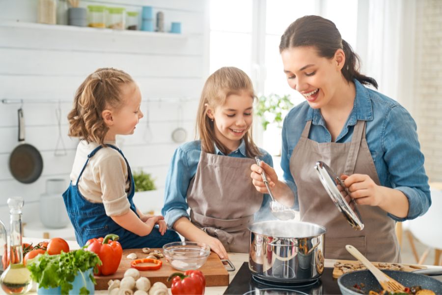 A busy mom cooking a quick and healthy dinner, representing weight loss solutions for busy lifestyles.