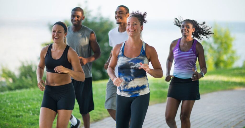 People jogging outdoors to promote physical activity for relieving constipation and improving digestion.